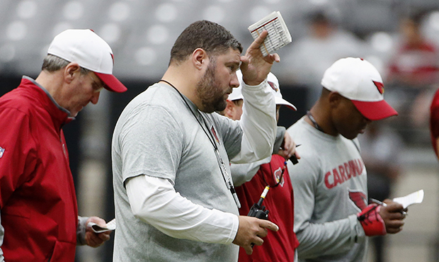 Arizona Cardinals new defensive coordinator James Bettcher, middle, watches his players against the...