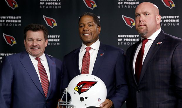 Newly appointed Arizona Cardinals football head coach Steve Wilks, center, poses for photographers ...
