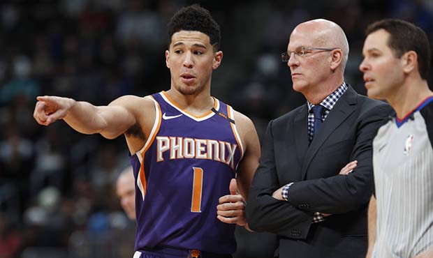 Phoenix Suns guard Devin Booker, left, confers with interim coach Jay Triano during the second half...