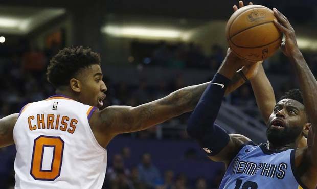 Memphis Grizzlies guard Tyreke Evans (12) tries to get off a shot past Phoenix Suns forward Marques...