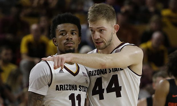 Arizona State guard Shannon Evans II (11) and Kodi Justice (44) in the first half during an NCAA co...