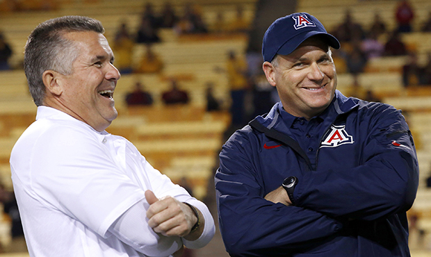 Arizona's head coach Rich Rodriguez, right, laughs with Arizona State's head coach Todd Graham prio...