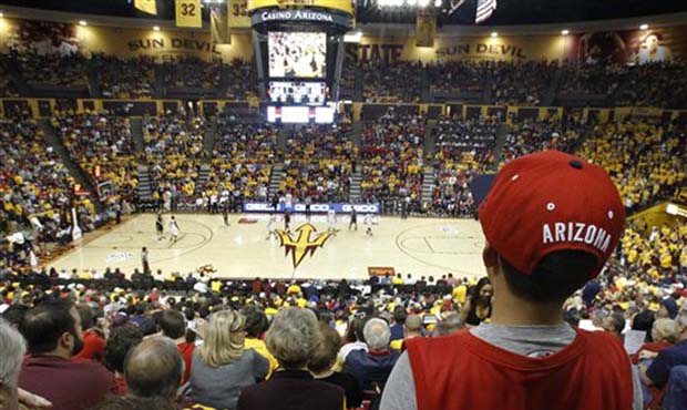 A young Arizona fan watches the action against Arizona State from high above at Wells Fargo Arena d...