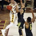 Arizona State guard Kodi Justice, left, tries to get off a pass against Oregon forward Paul White (13) and forward Troy Brown (0) during the second half of an NCAA college basketball game Thursday, Jan. 11, 2018, in Tempe, Ariz. Oregon defeated Arizona State 76-72. (AP Photo/Ross D. Franklin)