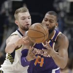 Phoenix Suns' Greg Monroe is defended by Indiana Pacers' Domantas Sabonis during the first half of an NBA basketball game Wednesday, Jan. 24, 2018, in Indianapolis. (AP Photo/Darron Cummings)