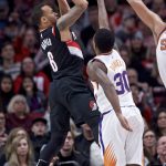 Portland Trail Blazers guard Shabazz Napier, left, shoots over Phoenix Suns guard Troy Daniels during the second half of an NBA basketball game in Portland, Ore., Tuesday, Jan. 16, 2018. (AP Photo/Craig Mitchelldyer)