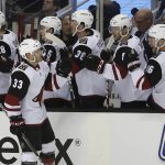 Arizona Coyotes defenseman Alex Goligoski (33) is congratulated by teammates after scoring a goal against the San Jose Sharks during the first period of an NHL hockey game Saturday, Jan. 13, 2018, in San Jose, Calif. (AP Photo/Tony Avelar)