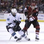 San Jose Sharks right wing Joel Ward (42) and Arizona Coyotes center Clayton Keller battle for the puck in the second period during an NHL hockey game, Tuesday, Jan. 16, 2018, in Glendale, Ariz. (AP Photo/Rick Scuteri)