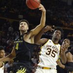 Oregon forward M.J. Cage (4) battles with Arizona State forward De'Quon Lake (35) for a rebound during the first half of an NCAA college basketball game, Thursday, Jan. 11, 2018, in Tempe, Ariz. (AP Photo/Ross D. Franklin)