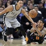 San Antonio Spurs guard Bryn Forbes (11) and Phoenix Suns guard Tyler Ulis (8) chase the ball during the first half of an NBA basketball game Friday, Jan. 5, 2018, in San Antonio. (AP Photo/Eric Gay)