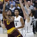 Arizona State guard Tra Holder, left, shoots as Colorado guard D'Shawn Schwartz, center, and forward Lucas Siewert defend during the first half of an NCAA college basketball game Thursday, Jan. 4, 2018, in Boulder, Colo. (AP Photo/David Zalubowski)