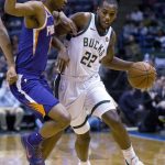 Milwaukee Bucks forward Khris Middleton, left, drives to the basket against the Phoenix Suns during the first half of an NBA basketball game Monday, Jan. 22, 2018, in Milwaukee. (AP Photo/Darren Hauck)