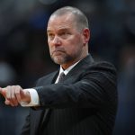 Denver Nuggets coach Michael Malone gestures during the first half of the team's NBA basketball game against the Phoenix Suns on Friday, Jan. 19, 2018, in Denver. (AP Photo/David Zalubowski)