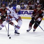 New York Rangers center Kevin Hayes (13) skates between Arizona Coyotes left wing Anthony Duclair, left, and Nick Cousins (25) in the third period during an NHL hockey game, Saturday, Jan. 6, 2018, in Glendale, Ariz. (AP Photo/Rick Scuteri)