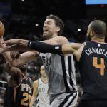 San Antonio Spurs center Pau Gasol (16) is fouled as he drives to the basket between Phoenix Suns defenders Josh Jackson (20) and Tyson Chandler (4) during the first half of an NBA basketball game, Friday, Jan. 5, 2018, in San Antonio. (AP Photo/Eric Gay)