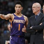 Phoenix Suns guard Devin Booker, left, confers with interim coach Jay Triano during the second half of the team's NBA basketball game against the Denver Nuggets on Wednesday, Jan. 3, 2018, in Denver. The Nuggets won 134-111. (AP Photo/David Zalubowski)
