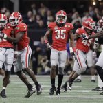 Georgia's Deandre Baker is congratulated after intercepting a pass during the second half of the NCAA college football playoff championship game against Alabama Monday, Jan. 8, 2018, in Atlanta. (AP Photo/David J. Phillip)