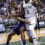 Milwaukee Bucks guard Eric Bledsoe, right, and Phoenix Suns forward TJ Warren, left, battle for the loose ball during the second half of an NBA basketball game, Monday, Jan. 22, 2018, in Milwaukee. (AP Photo/Darren Hauck)