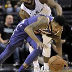 Phoenix Suns guard Troy Daniels, bottom, and Memphis Grizzlies guard Tyreke Evans struggle for control of the ball in the second half of an NBA basketball game Monday, Jan. 29, 2018, in Memphis, Tenn. (AP Photo/Brandon Dill)
