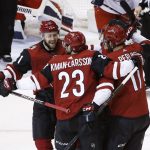 Arizona Coyotes left wing Brendan Perlini (11) celebrates his goal against the Columbus Blue Jackets with defenseman Oliver Ekman-Larsson (23) and center Derek Stepan (21) during the third period of an NHL hockey game Thursday, Jan. 25, 2018, in Glendale, Ariz. The Blue Jackets defeated the Coyotes 2-1. (AP Photo/Ross D. Franklin)