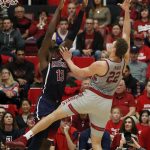 Stanford forward Reid Travis (22) takes a shot over Arizona forward Deandre Ayton (13) during the first half of an NCAA college basketball game Saturday, Jan. 20, 2018, in Stanford, Calif. (AP Photo/Tony Avelar)