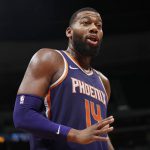 Phoenix Suns center Greg Monroe argues a call with a referee during the second half of the team's NBA basketball game against the Denver Nuggets on Wednesday, Jan. 3, 2018, in Denver. The Nuggets won 134-111. (AP Photo/David Zalubowski)