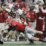 Georgia's Jake Fromm tackles Alabama's Raekwon Davis after an interception during the second half of the NCAA college football playoff championship game Monday, Jan. 8, 2018, in Atlanta. (AP Photo/David J. Phillip)