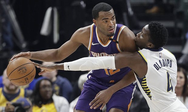 Phoenix Suns' TJ Warren is defended by Indiana Pacers' Victor Oladipo during the first half of an N...
