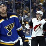 Arizona Coyotes' Brendan Perlini, right, celebrates after scoring as St. Louis Blues' Joel Edmundson, left, skates past during the first period of an NHL hockey game Saturday, Jan. 20, 2018, in St. Louis. (AP Photo/Jeff Roberson)