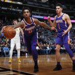 Phoenix Suns forward Marquese Chriss, front left, reaches out to pull in a loose ball as guard Devin Booker, front right, and Denver Nuggets center Nikola Jokic, of Serbia, look on in the first half of an NBA basketball game Wednesday, Jan. 3, 2018, in Denver. (AP Photo/David Zalubowski)