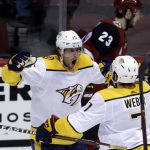 Nashville Predators right wing Craig Smith (15) celebrates with Yannick Weber (7) after scoring during the third period of the team's NHL hockey game against the Nashville Predators, Thursday, Jan. 4, 2018, in Glendale, Ariz. The Coyotes defeated the Predators 3-2. (AP Photo/Rick Scuteri)