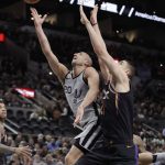 San Antonio Spurs guard Manu Ginobili (20) shoots past Phoenix Suns center Alex Len (21) during the first half of an NBA basketball game Friday, Jan. 5, 2018, in San Antonio. (AP Photo/Eric Gay)