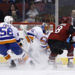 New York Islanders goaltender Jaroslav Halak (41) gives up a goal to Arizona Coyotes' Nick Cousins as Islanders center Tanner Fritz (56) and Coyotes left wing Jordan Martinook (48) watch during the first period of an NHL hockey game, Monday, Jan. 22, 2018, in Glendale, Ariz. (AP Photo/Ross D. Franklin)