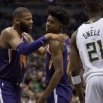 Phoenix Suns center Greg Monroe, left, talks with Josh Jackson, center, after he was fouled by the Milwaukee Bucks during the second half of an NBA basketball game Monday, Jan. 22, 2018, in Milwaukee. (AP Photo/Darren Hauck)