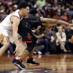 Phoenix Suns guard Devin Booker, left, fouls Houston Rockets guard Chris Paul during the second half of an NBA basketball game Friday, Jan. 12, 2018, in Phoenix. (AP Photo/Matt York)