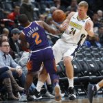 Phoenix Suns guard Isaiah Canaan, left, loses the ball as he collides with Denver Nuggets center Mason Plumlee in the first half of an NBA basketball game Wednesday, Jan. 3, 2018, in Denver. (AP Photo/David Zalubowski)
