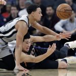 San Antonio Spurs guard Bryn Forbes, left, and Phoenix Suns guard Devin Booker, right, scramble for a loose ball during the second half of an NBA basketball game Friday, Jan. 5, 2018, in San Antonio. San Antonio won 103-89. (AP Photo/Eric Gay)