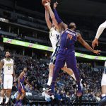 Denver Nuggets center Mason Plumlee, back, pulls in a rebound as Phoenix Suns center Greg Monroe defends in the second half of an NBA basketball game Wednesday, Jan. 3, 2018, in Denver. The Nuggets won 134-111. (AP Photo/David Zalubowski)