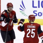 Arizona Coyotes left wing Brendan Perlini (11) celebrates his goal against the New York Islanders with center Nick Cousins (25) during the second period of an NHL hockey game, Monday, Jan. 22, 2018, in Glendale, Ariz. (AP Photo/Ross D. Franklin)