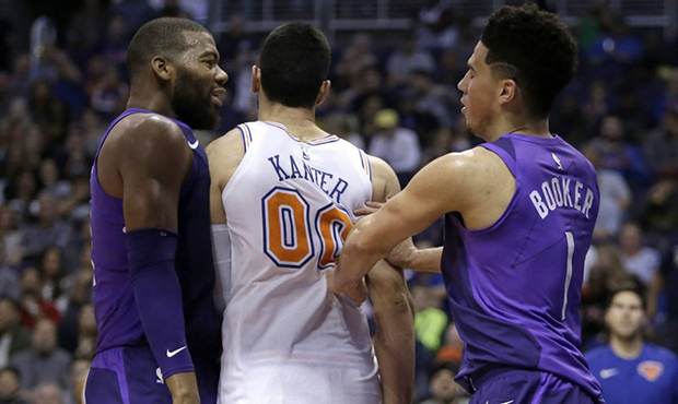 Phoenix Suns guard Devin Booker (1) and Greg Monroe get into a shoving match with New York Knicks c...