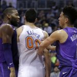 Phoenix Suns guard Devin Booker (1) and Willy Hernangomez get into a shoving match with New York Knicks center Enes Kanter (00) during the second half of an NBA basketball game Friday, Jan. 26, 2018, in Phoenix. The Knicks defeated the Suns 107-85. (AP Photo/Rick Scuteri)