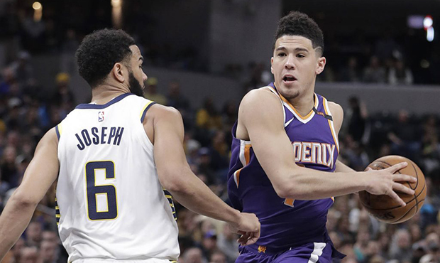 Phoenix Suns' Devin Booker goes to the basket against Indiana Pacers' Cory Joseph during the second...