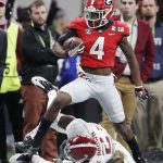 Georgia wide receiver Mecole Hardmangets past Alabama defensive back Tony Brown for a touchdown catch during the second half of the NCAA college football playoff championship game Monday, Jan. 8, 2018, in Atlanta. (AP Photo/David Goldman)