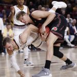 Utah forward Jayce Johnson, right, and Arizona State forward Mickey Mitchell get tangled up during a jump ball during the first half of an NCAA college basketball game, Thursday, Jan. 25, 2018,in Tempe, Ariz. (AP Photo/Matt York)