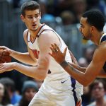 Phoenix Suns forward Dragan Bender, left, looks to pass the ball as Denver Nuggets forward Trey Lyles defends during the first half of an NBA basketball game Friday, Jan. 19, 2018, in Denver. (AP Photo/David Zalubowski)