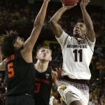 Arizona State guard Shannon Evans II (11) shoots over Oregon State forward Tres Tinkle (3) and Ethan Thompson (5) during the second half of an NCAA college basketball game Saturday, Jan. 13, 2018, in Tempe, Ariz. Arizona State defeated Oregon State 77-75. (AP Photo/Rick Scuteri)
