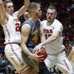Utah's David Collette, right, and Tyler Rawson, left, defend against Arizona State guard Kodi Justice, center, in the first half of an NCAA college basketball game Sunday, Jan. 7, 2018, in Salt Lake City. (AP Photo/Rick Bowmer)