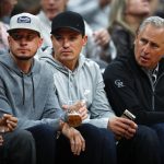 From left to right, Colorado Rockies relief pitcher Chris Rusin, left, joins catcher Tony Wolters and manager Bud Black in courtside seats to watch the Denver Nuggets host the Phoenix Suns in an NBA basketball game Friday, Jan. 19, 2018, in Denver. (AP Photo/David Zalubowski)