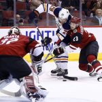 Arizona Coyotes defenseman Oliver Ekman-Larsson (23) shoves Edmonton Oilers center Leon Draisaitl (29) off his shot as Coyotes goaltender Antti Raanta (32) waits for the puck during the first period of an NHL hockey game, Friday, Jan. 12, 2018, in Glendale, Ariz. (AP Photo/Ross D. Franklin)