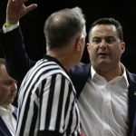 Arizona head coach Sean Miller, right, talks with NCAA official Dick Cartnell in the second half during an NCAA college basketball game against Utah, Saturday, Jan. 27, 2018, in Tucson, Ariz. (AP Photo/Rick Scuteri)